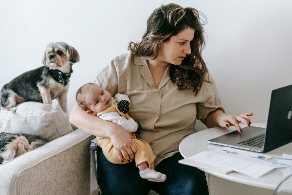 Caregiver of a baby juggling other tasks