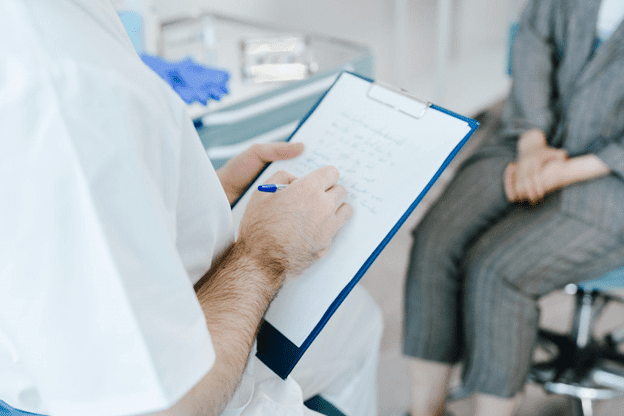 A doctor taking notes for the patient.