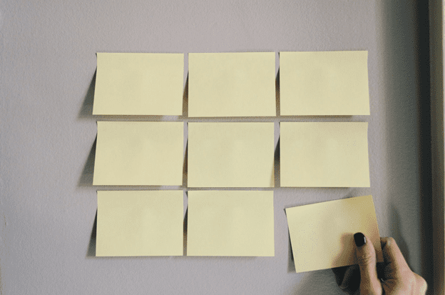 Post-it sticky notes on the wall for writing down an emergency contact list for caregivers.