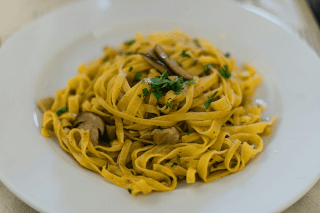 Photo of a homemade tagliatelle pasta in a plate.